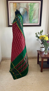 PRARTHI - RED PATOLA WITH SLANTED IKAT BODY AND GREEN BORDER