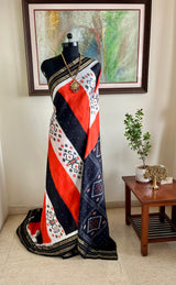 EKANTAA – POCHAMPALLY SILK IN ORANGE, BLACK, WHITE WITH IKAT GRID