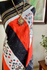 EKANTAA – POCHAMPALLY SILK IN ORANGE, BLACK, WHITE WITH IKAT GRID