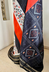 EKANTAA – POCHAMPALLY SILK IN ORANGE, BLACK, WHITE WITH IKAT GRID