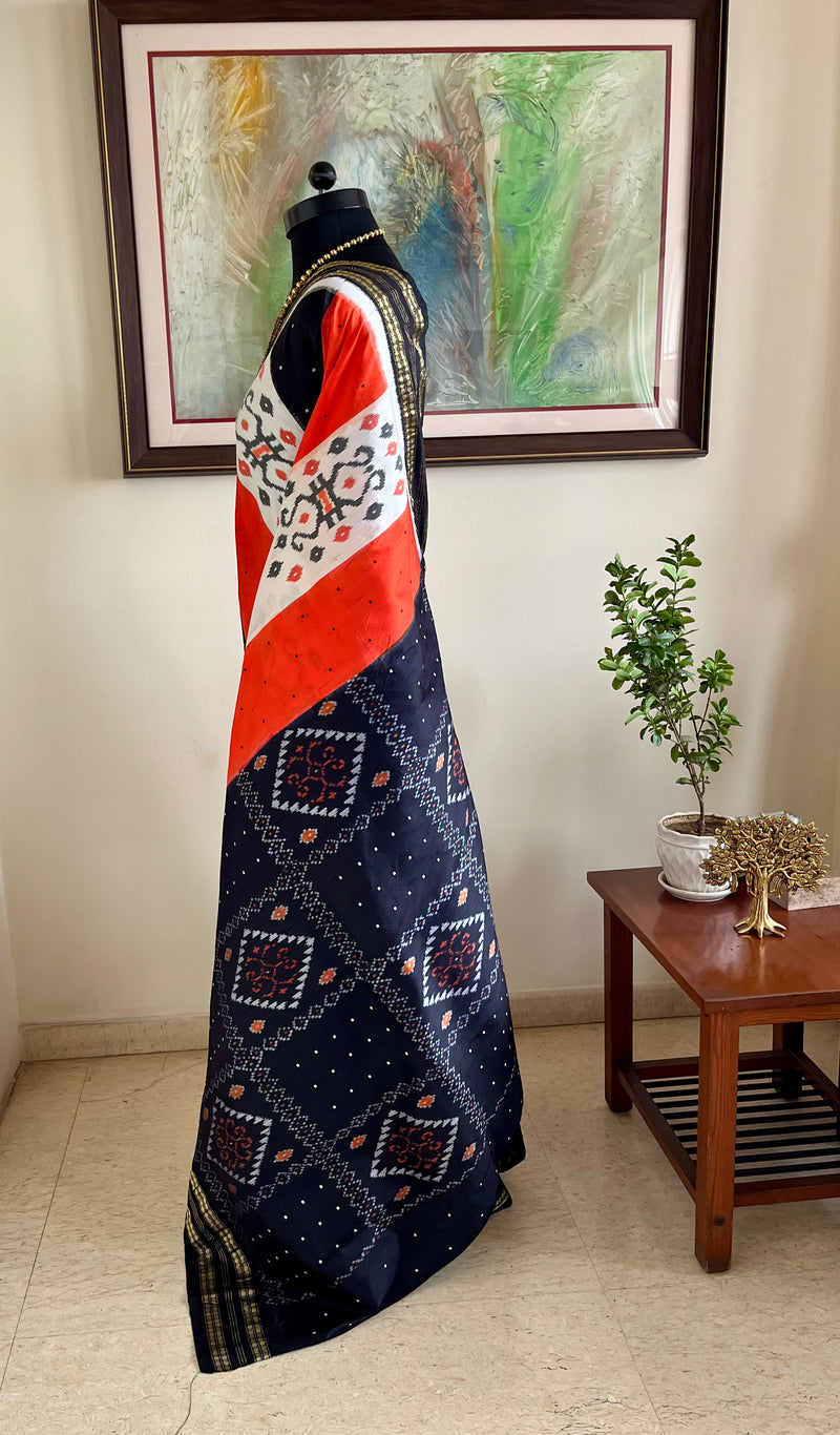 EKANTAA – POCHAMPALLY SILK IN ORANGE, BLACK, WHITE WITH IKAT GRID
