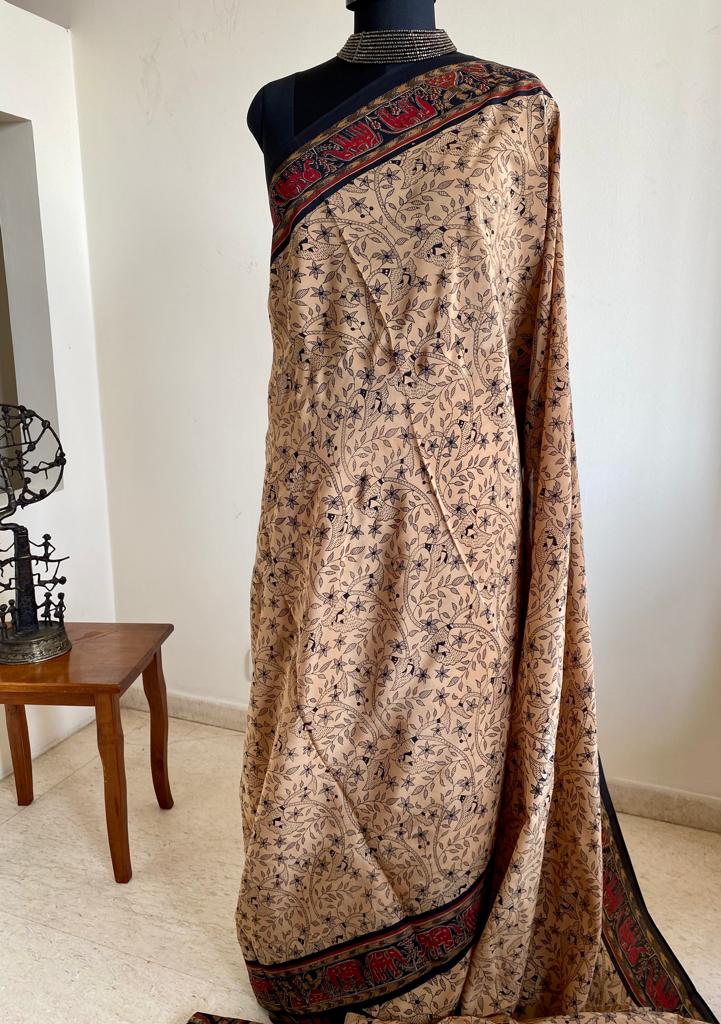 EMMA- PURE, ITALIAN CREPE IN BEIGE WITH PRINTED FLORAL MOTIFS IN BLACK AND A CONTRAST AANCHAL IN RED WITH FLORAL AND ANIMAL MOTIFS