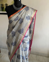 BAMINI- A BEAUTIFUL OFFWHITE CHANDERI WITH BLACK FLORAL BANARASI WEAVE MOTIFS AND ZARI BORDER
