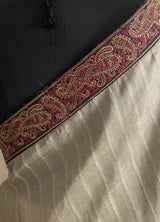 PAAVANI- AN UNUSAL KHAKI BEIGE TUSSAR WITH AN EMBROIDERED BORDER RUNNING THROUGH THE LENGTH OF THE SAREE.