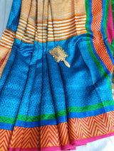 UMA- A PRINTED BLUE SILK WITH  MULTILAYERS IN BLUE, GREEN AND CHEVRON IN BROWN AND OFFWHITE BORDER AND AANCHAL