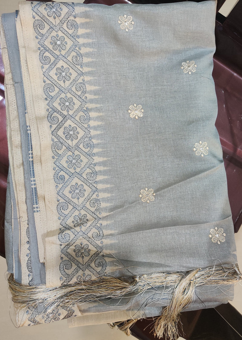 ISRA- A GREY TUSSAR SILK BLEND SAREE WITH FLORAL EMBROIDERY ON THE BODY AND BORDER