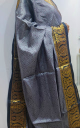 CHANDANIYA- A GREYISH SILVER ART SILK SAREE WITH SELF WEAVE IN THE BODY, AANCHAL IN A CONTRAST COLOURED WEAVE AND GOLDEN ZARI BORDER