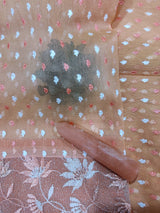 BIJAYA- A LIGHT PEACH COLOURED SUPERNET SAREE WITH BEAUTIFUL PATTERN ALL OVER THE BODY AND ZARI ROSE GOLDEN BORDER