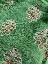 ARUSHI- A PRINTED PURE GEORGETTE IN GREEN WITH  EMBROIDERY AND SEQUIN WORK IN THE BODY, SEQUINED BORDER